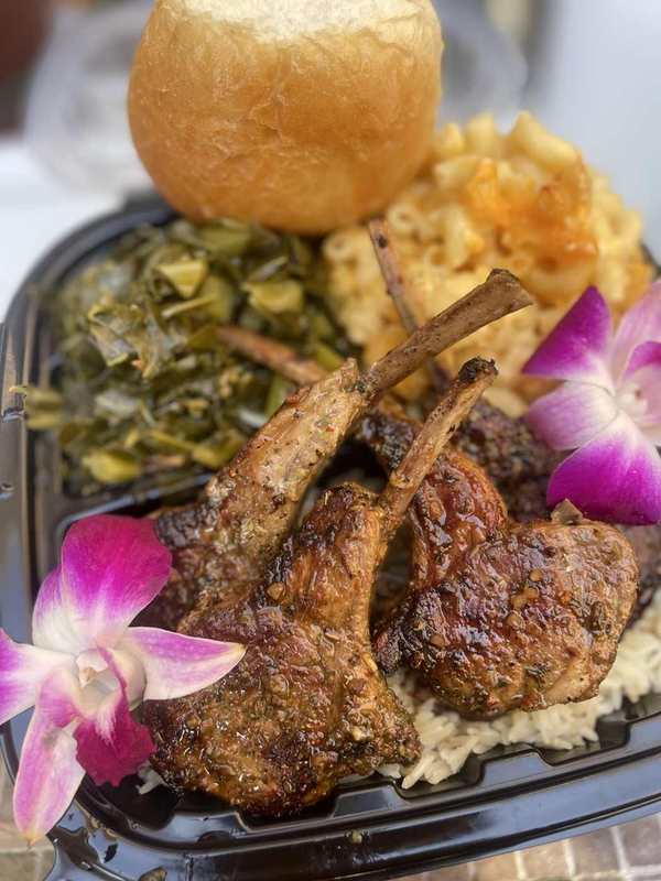 Seasoned lamb chops plated with homestyle sides